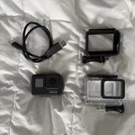 Gopro Hero 7 Black Action Camera With Regular And Waterproof Case Cord. Fixed Price $89.00.